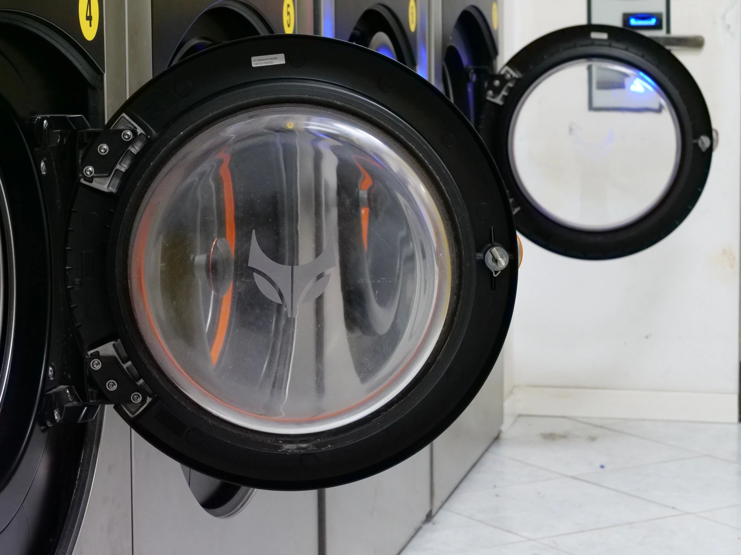 Open washing machine doors in a bright laundry setting